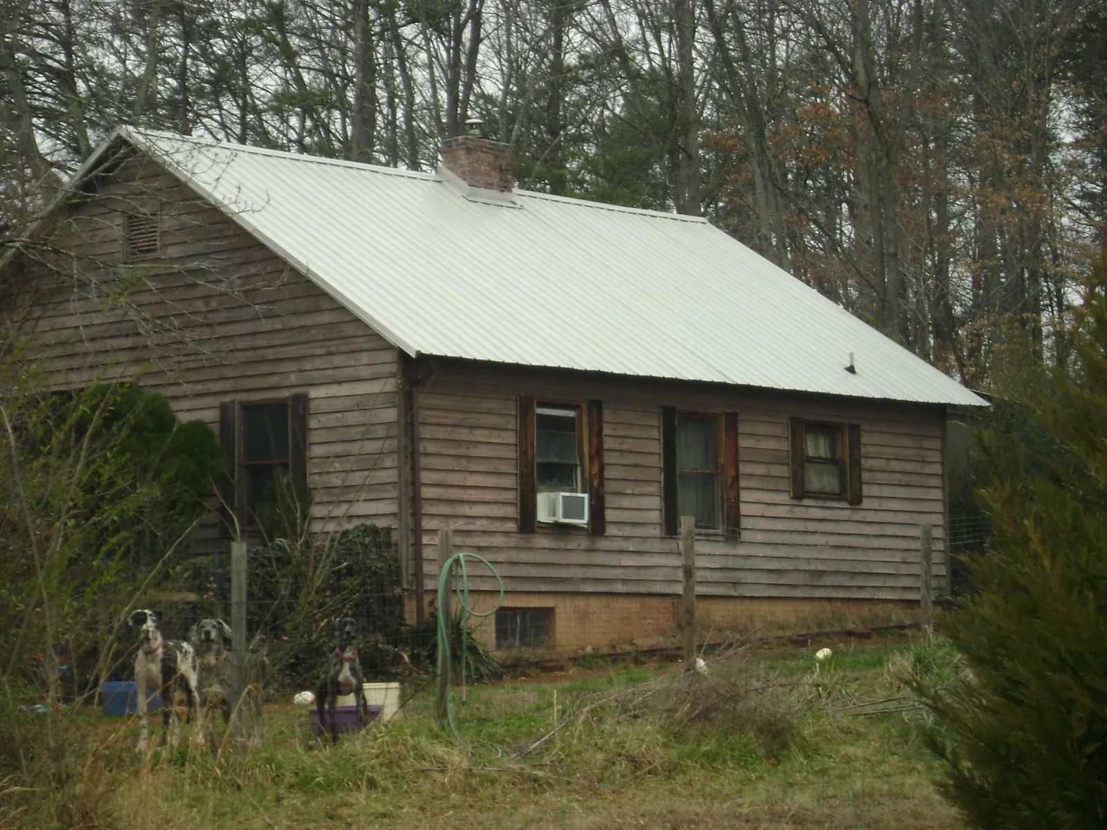 White metal roof on an old wood sided farmhouse, from a Metal Roof Installation job in Hartford